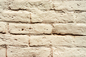 Texture of a brick wall with cracks and scratches which can be used as a background