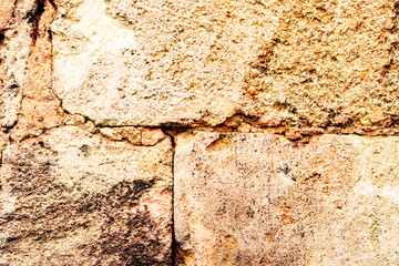 Texture of a brick wall with cracks and scratches which can be used as a background