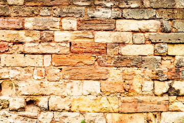 Texture of a brick wall with cracks and scratches which can be used as a background