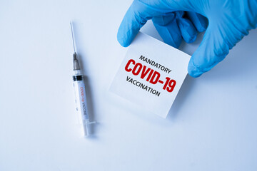 mandatory covid-19 vaccination. medicine, healthcare and pandemic concept. medical mask, syringe...