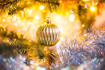 Christmas decoration on a tree, gold ball with boke around