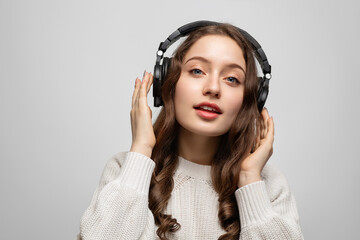 Girl in black headphones listening to music