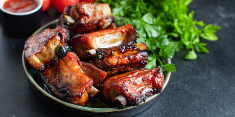 ribs meat pieces on the bone and lard fat grilled BBQ sauce second course snack ready to eat on the table meal top view copy space for text food background rustic image