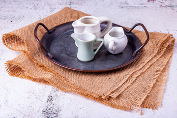 Three portion jugs for cream or milk on vintage metal tray