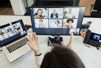 Businesswoman video conferencing with colleagues at computer screen