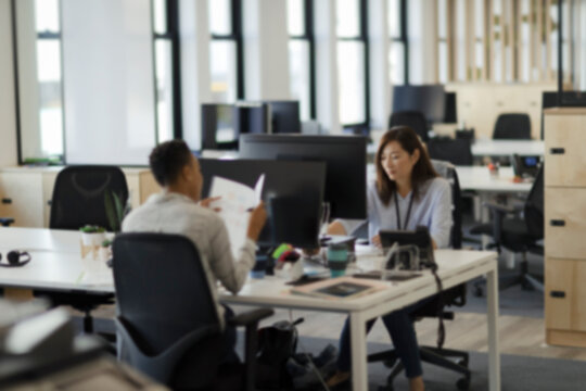 Businesswomen working at computers in open plan office