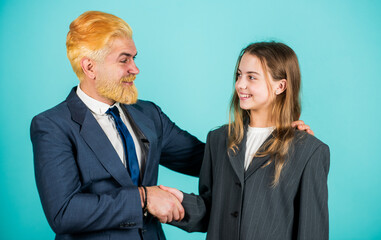 Welcome on board. business meeting. modern office life. businessman dyed blond hair. small girl in oversized suit jacket. future career. family business. partnership. teamwork of daughter and dad