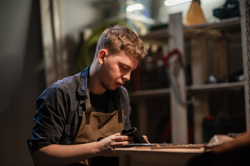 a hereditary shoemaker makes shoes from leather in the family workshop