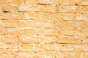 Texture of a brick wall with cracks and scratches which can be used as a background