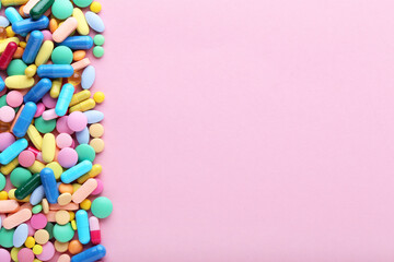 Fototapeta na wymiar Colorful pills on pink background