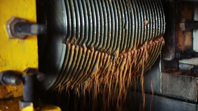 Machinery straining agave pulp into juice