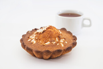  cupcake and a cup of tea on a white background.