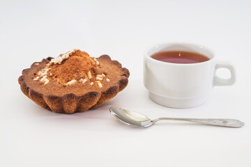  cupcake and a cup of tea on a white background.