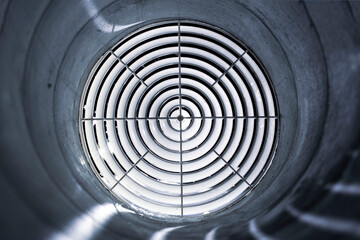Obraz premium ventilation grill diffuser close-up mounted in the duct at night, the front and background are blurred