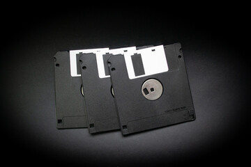 Close-up of three black old floppy disks or diskettes  for electronic storage - concept for old technology or secret information - 401075189