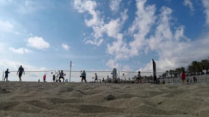 People playing tennis on the beach in barcelona