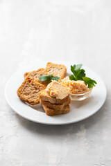 toasts with fish pate on white plate