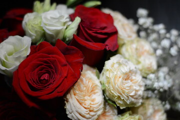 Bouquet of white and red roses on a dark background