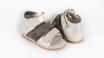 children's white and brown orthopedic sandals on a white background