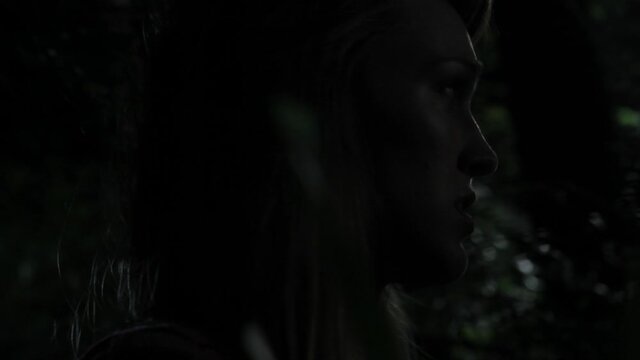Close up of Caucasian woman scared in woods at night