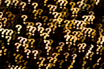 Yellow question marks bokeh lights background abstract pattern on black background.