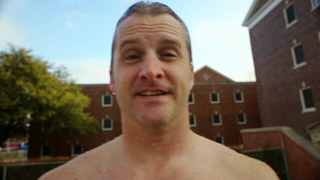 Close up of smiling Caucasian man with wet hair raising eyebrow