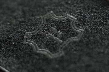 Closeup of real leather symbol engraved on black leather