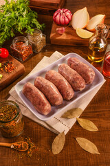 Obraz na płótnie Canvas Brazilian pork sausage with chimichurri on white plate with spices and ingredients