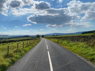 Fototapeta na wymiar Looking along the, B6478 road, on a cloudy day in, Slaidburn, Clitheroe, UK