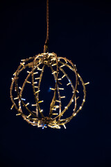 Vertical view of the crescent moon inside a Christmas illuminated ball Christmas card to congratulate the holidays. Real photograph