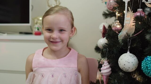 Portrait Of Funny Little Girl Smiling Child Blogger Or Vlogger Social Media Looking And Talking Speaking At Camera Webcam, Recording Vlog At Christmas X'mas Tree Home. Kid, Making Online Video Call