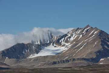 Fototapeta premium Mountains, glaciers and coastline landscape close to a village called 
