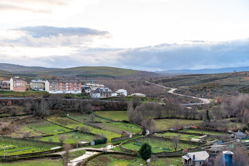 Fototapeta na wymiar Panoramic view of the orchards and modern buildings together with roads and highways that can be seen from the top of Puebla de Sanabria