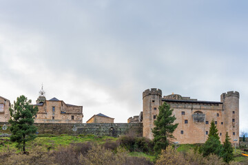 Fototapeta premium Panoramic view of the old town of Puebla de Sanabria with its castle on the right, church, houses and wall decorated with Christmas lights in the evening