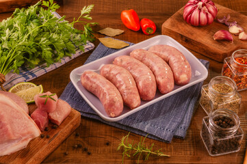 Brazilian pork leg sausage on white plate with spices and ingredients - Linguiça de pernil