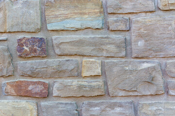 Fototapeta premium bright mediterranean stone wall with copy space, background.