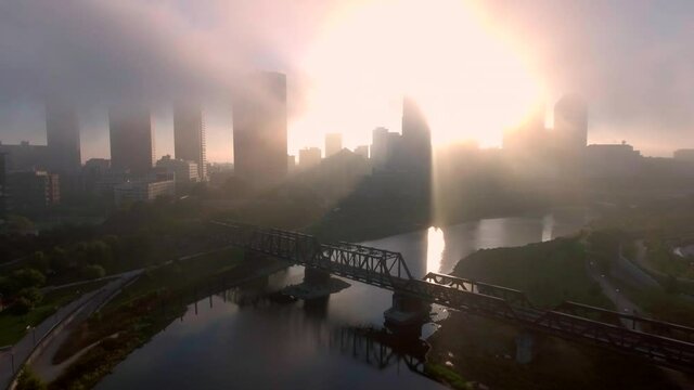 Drone aerial establishing shot of downtown city of Columbus, Ohio buildings during a contrast heavy, early morning fog in the cold, fall weather 2020