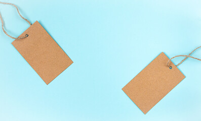 Blank craft paper cloth tag or label on blue background