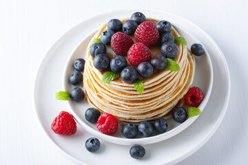 Traditional Russian pancakes with berries. Maslenitsa week. Pancake week.