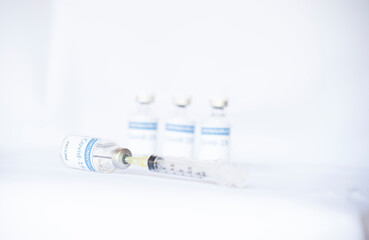 Vaccine covid19 in vials with syringe isolated white background, Mers-Cov ,Concept vaccine in vials for stop. Flu coronavirus pathogen that attacks the respiratory tract. Pandemic virus infection.