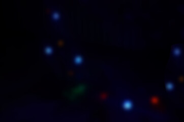 Obraz premium Bright, glowing garland in the dark, multi-colored balls. New Year, decorations for the Christmas tree.