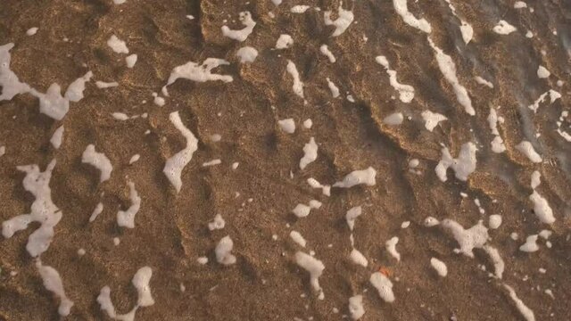 We're leaving behind a very bad year. 2020 written on the beach disappears into the waves. Goodbye 2020 welcome 2021