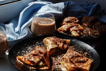 Chocolate pancakes and coffee for breakfast in the sunny morning