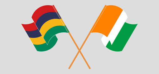 Crossed and waving flags of Mauritius and Republic of Ivory Coast