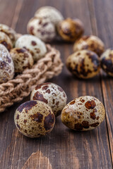 Fototapeta premium Quail eggs on the wooden plate. Quail eggs can be consumed by frying or boiling. In Indonesia quail eggs called telur puyuh.