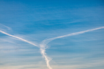 Fototapeta na wymiar Several white condensation airplane trace in deep blue sky