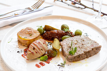 assorted pates on a plate on white wooden table