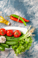 top view fresh green onion with tomatoes and greens on light-blue background meal ripe color salad photo