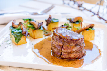 grilled steak filet Mignon on white plate with garnish
