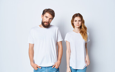 Fototapeta premium handsome guy explains something to a young woman on a light background cropped view family Copy Space